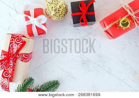 Christmas Decorative Background With Fir Branches, Cones, Redr And Black Christmas  Gifts, Ball On T