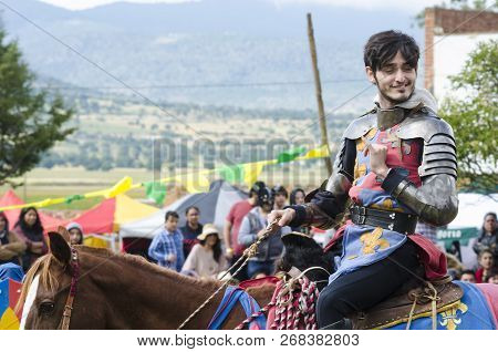 Tlaxcala, Mexico- September 29, 2018: Young Knight Riding A Horse And Smiling At The Audience At Med