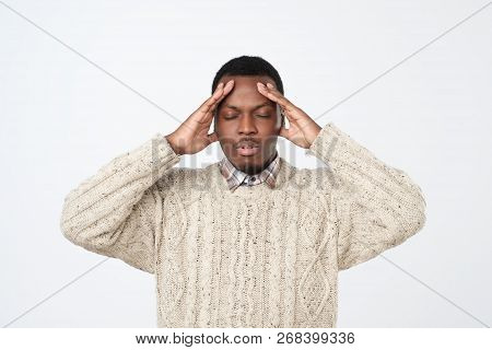 African Young Man, Slapping Hand On Head Having A Duh Moment Isolated On Gray Background.