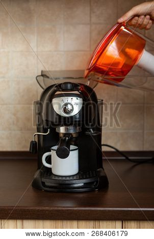 Photo Of Hand Of Man Pouring Water From Jug Into Coffee Maker In Kitchen