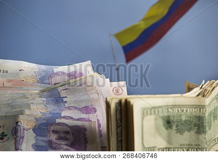 Savings In Search Of The Dream Of Traveling To Colombia - Colombian Banknotes And Dollars With The C