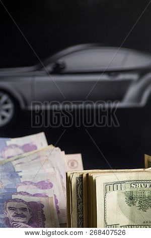Project To Buy A Car- Colombian Dollars And Money With Black Car In The Background