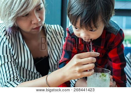 Sigle Mom Help Child Drinking Water From Straw Between Working.