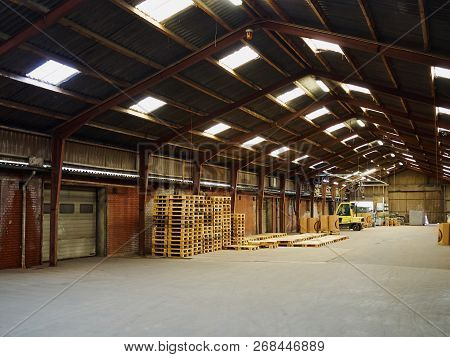 Inside Agriculture Farm Strorage Warehouse With Pallets And A Fork Lift