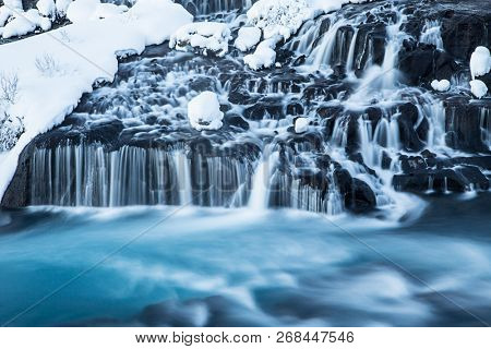 Hraunfossar waterfall in winter, long exposure. One of the most popular waterfall in Iceland, Europe.