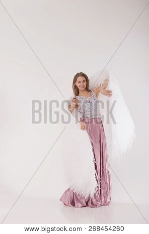 Girl In Pink Dress With Angel Wings On White Background. Angel-woman