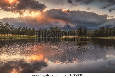 Strba Pond Lit By Golden Light At Sunset With High Tatras Mountains In Background, Slovakia.