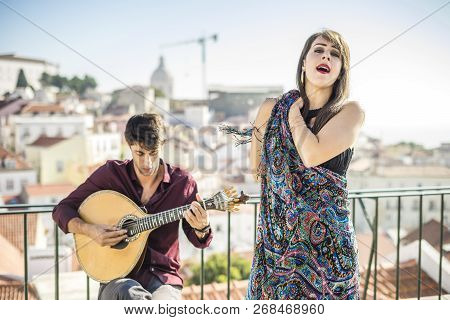 Beautiful Fado Singer Performing With Handsome Portuguese Guitarist Player, Portugal