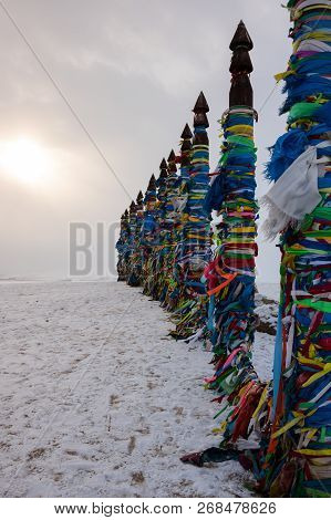 Wooden Ritual Pillars With Colorful Ribbons On Cape Burkhan, Lake Baikal, Olkhon Island, Siberia, Ru