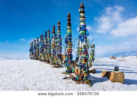 Wooden Ritual Pillars With Colorful Ribbons On Cape Burkhan, Lake Baikal, Olkhon Island, Siberia, Ru