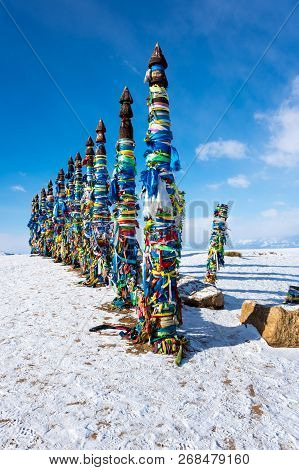 Wooden Ritual Pillars With Colorful Ribbons On Cape Burkhan, Lake Baikal, Olkhon Island, Siberia, Ru