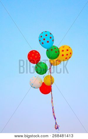 Helium Balloons. Colorful helium balloons. Floating away in the blue sky. Birthday Balloons. Party Time.