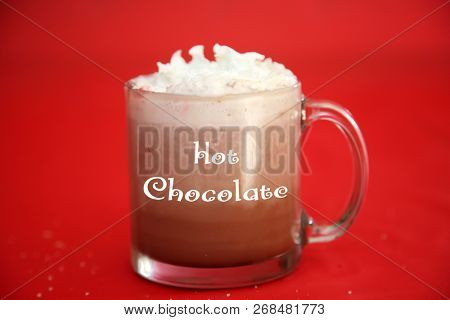 Hot Chocolate. Hot Coco in a glass mug with whip cream, cookies and text. Red Christmas background. Room for text