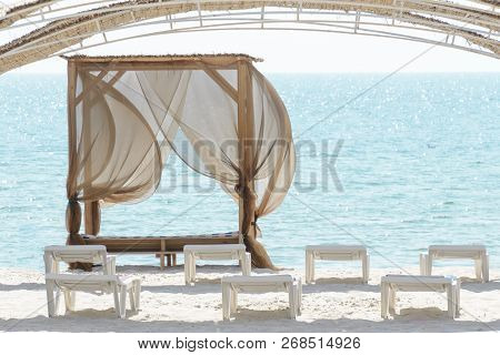 Empty Beach Beds. Lounge Chaise On A Sand Shore, Sun Umbrellas Omission, Empty Beach, Summer