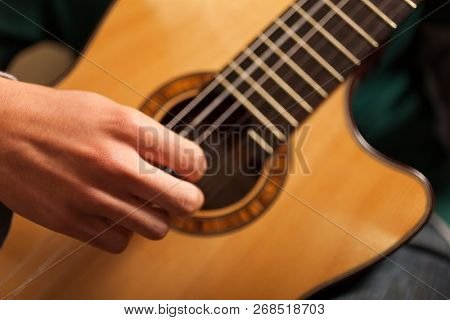 Detail of a classical guitar player