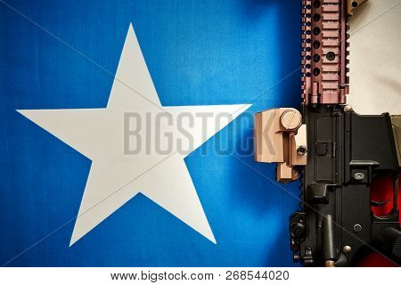 Top View Of A Machine Gun Located On The Background Of The Texas Flag