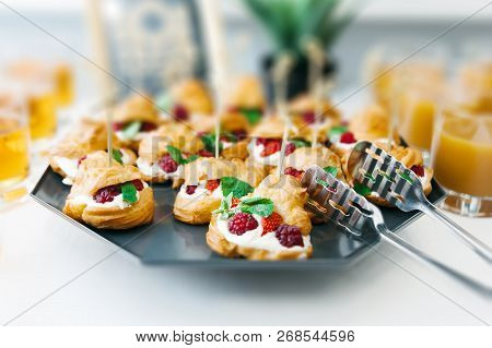 Sweet Catering With Berry Cackes And Juice At White Table