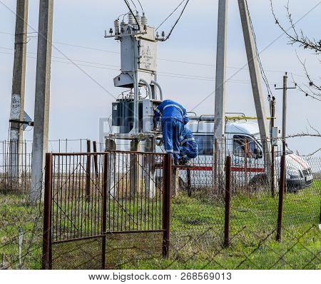 Krasnodar, Russia - March 23, 2018: Electricians Repair Electrical Transformer. Repair Team On The R