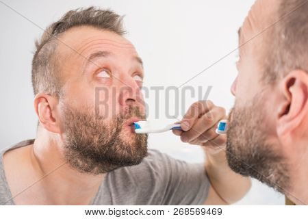 Funnny Guy Taking Care Of His Oral Hygiene, Brushing Teeth During Morning Bathroom Routine.