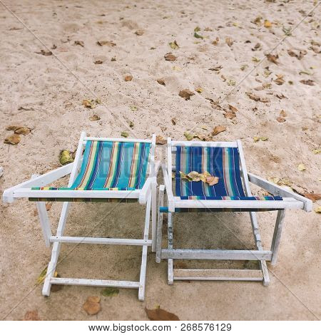 Two Empty Deck Chairs With Blue And Green Stripes For Relazation On The Beach, Summer Holiday Concep