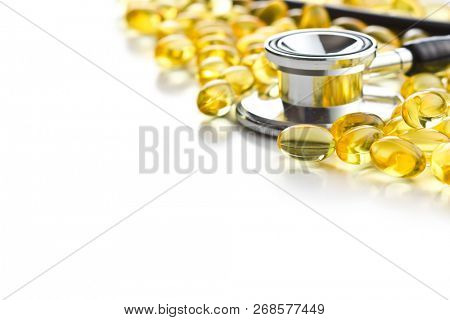 Omega 3 gel capsules. Fish oil pills. Healthy omega-3 and stethoscope isolated on white background.