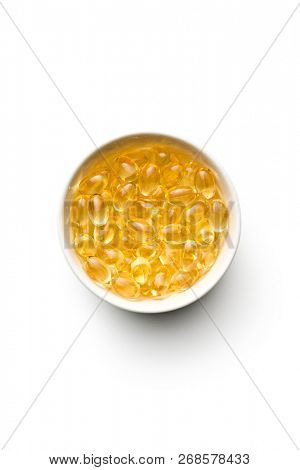 Omega 3 gel capsules. Fish oil pills. Healthy omega-3 in bowl.