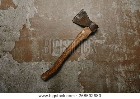 Top View Of Vintage Rusty Axe On Old Surface