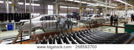 Engineer Looks Into The Cab Of The Car On The Production Line. Automotive Production Line. Long Form