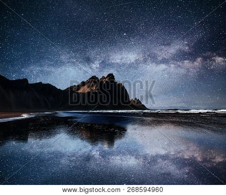 Amazing Mountains Reflected In The Water At Starry Night. Stoksnes, Iceland.