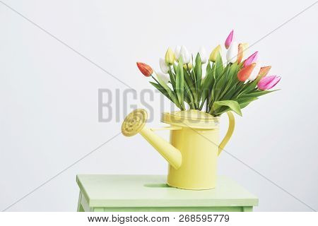 Yellow Funnel With Small Colored Flowers Tulps. Beutiful Spring Flowers.