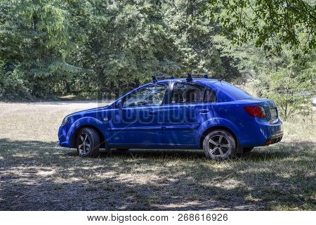 Forests Next To The Village Of Shapsugskaya, Russia - July 30, 2016: The Blue Car Of Kia Rio Is Unde