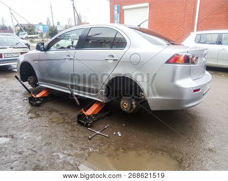 Krasnodar, Russia - March 15, 2017: The Car Is At The Tire Shop. Under The Jack The Car In Car-care 