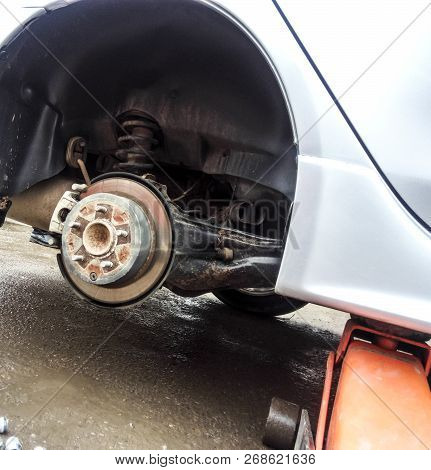 The Car Is At The Tire Shop. Under The Jack The Car In Car-care Center. The Car With The Removed Whe