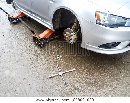 The Car Is At The Tire Shop. Under The Jack The Car In Car-care Center. The Car With The Removed Whe
