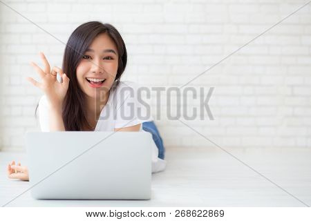 Beautiful Portrait Asian Young Woman Working Online Laptop With Excited Lying On Floor Brick Cement 