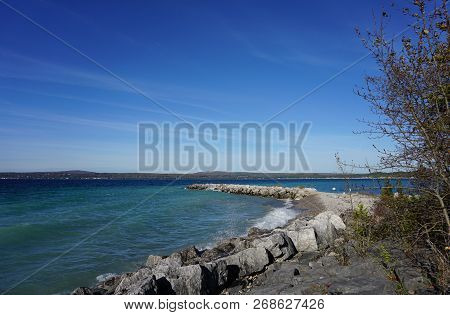 Boulders Serve As A Breakwall To Protect The Bay View Swimming Beach From The Effect Of Waves, In Ba