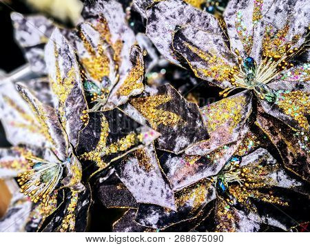 Closeup Of Beautiful Light Christmas Decoration With Black And Golden Flowers In The Shop. Backgroun