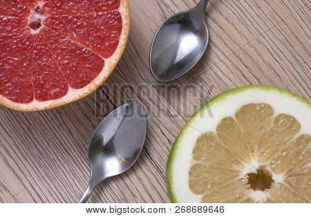 Green Sweetie Or Pomelit And Red Grapefruit On Wooden Background. Top View.