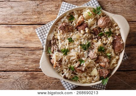 Delicious Traditional Estonian Mulgikapsas  Stewed Pork With Sauerkraut And Barley Close-up In A Pan