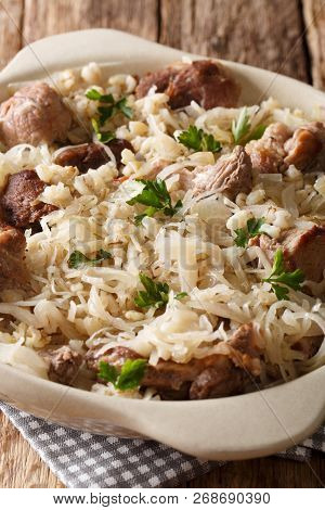 Estonian Traditional Dish Mulgikapsas Pork Cooked With Sauerkraut And Barley Closeup In A Pan. Verti