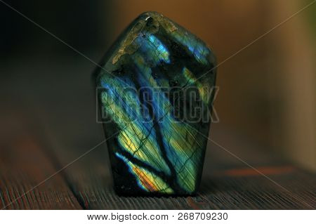 Polished Blue Labradorite On A Wooden Background