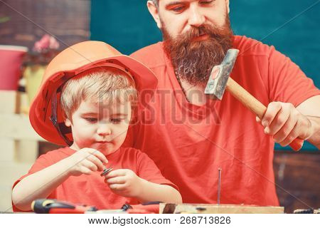 Masculine Duties Concept. Father, Parent With Beard Teaching Little Son To Use Hobnails And Hammer. 