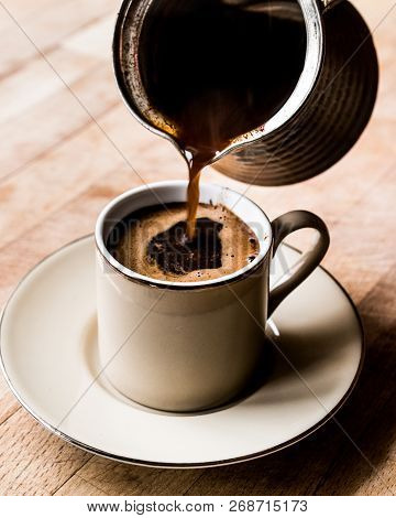 Pouring Turkish Coffee Into The Cup.