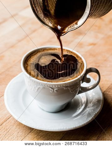 Pouring Turkish Coffee Into The Cup.