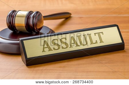 A Gavel And A Name Plate With The Engraving Assault