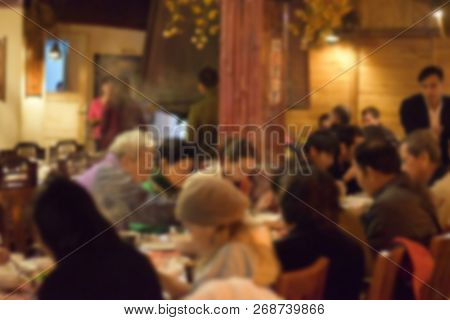 Blurred Of Group Of People Enjoy Eating Lunch Or Dinner In The Restaurant