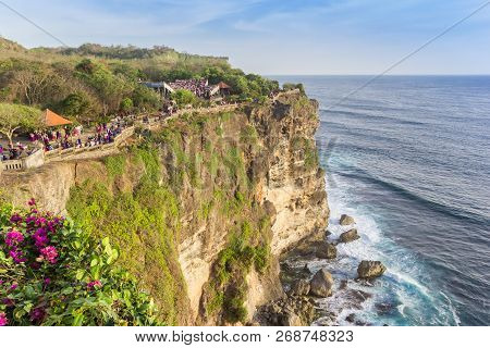 People Walking On The Edge Of The Cliffs At Ulu Watu, Bali, Indonesia
