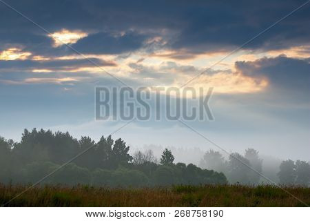 Beautiful Landscape With Mist. Summer Beautiful Idyllic Landscape In Latvia. Meadow, Wood And Sky Wi