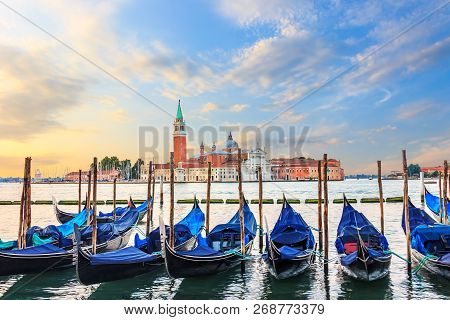 Gondolas Moored At The Pier In Grand Canal With San Giorgio Magg