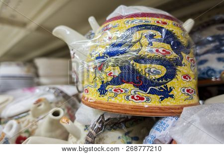 New Orleans, Usa - Dec 3, 2017: Chinese Ceramic Teapot With Dragon Motif Stacked Up On Display For S
